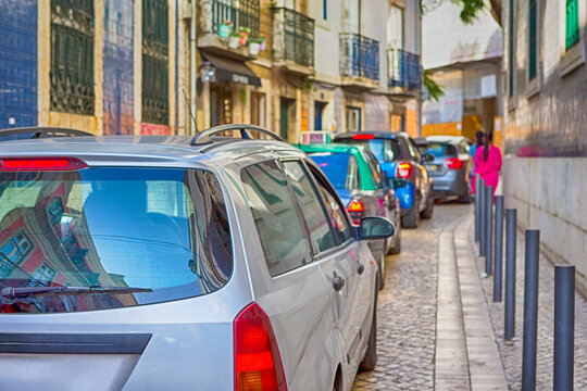 Portugal Travel Ideas. Blurred Image of People Traveling Through the Colorful Streets of Lisbon With Line of Cars