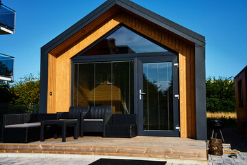 Relax corner with garden furniture at house terrace. Lounge zone in modern family house