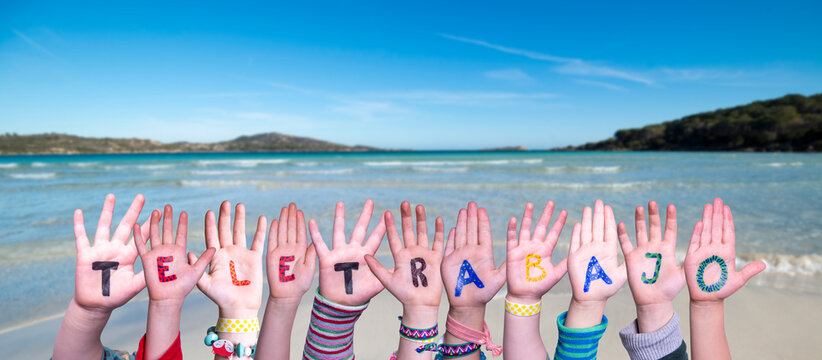 Children Hands Building Word Teletrabajo Means Teleworking, Ocean And Sea