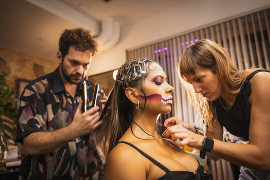 Preparations for the Halloween party, working the stylist and the hairdresser on the makeup and hairstyle in the beauty salon