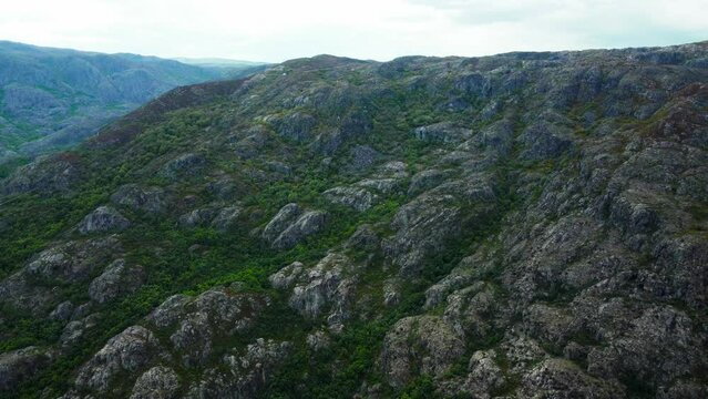 Rocky hillslope of rio tera canyon and exposed stone covered in greenery
