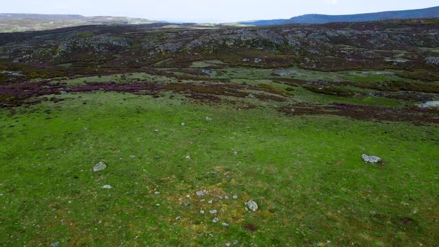 Beautiful sprawling grassy hillside with exposed rocks of arroyo de los toriles spain