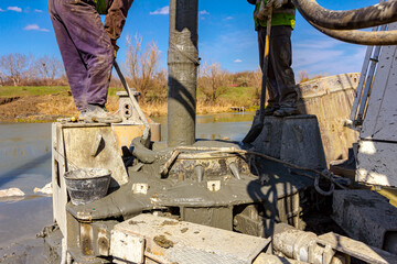 Pouring liquid concrete in bridge foundation