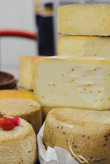 hand made baked stuffed rolls and pieces of cheese. Delicious pastries on wooden cutting board and parchment paper at the street food fair. Soft focus blurred and noise effect