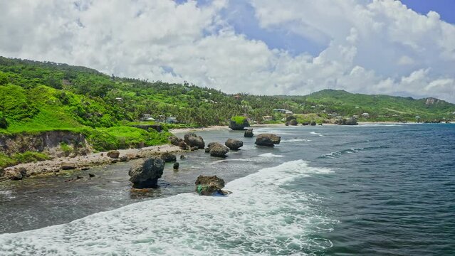 Dynamic low angle aerial of Soup Bowl beach. Bathsheba, Barbados