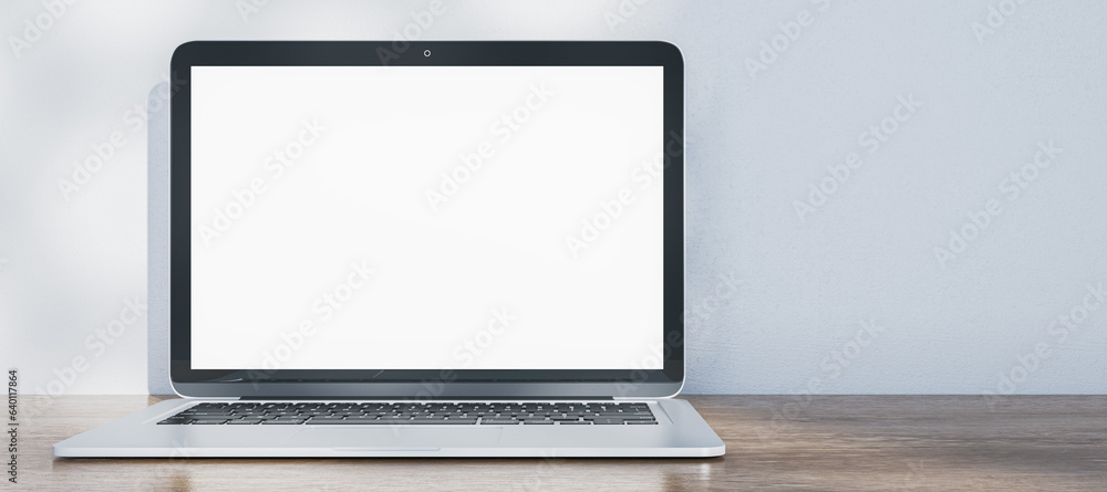 Aufkleber Wide image of laptop with empty white mock up screen placed on wooden desk. Concrete wall with shadows in the background. 3D Rendering.