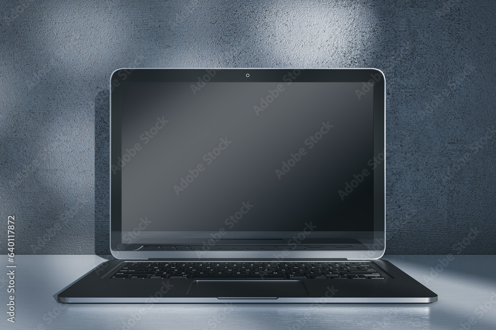 Poster Close up of laptop computer with empty mock up screen placed on desk. Concrete wall with shadows in the background. 3D Rendering.