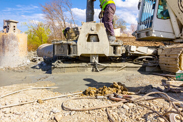 Pouring liquid concrete in bridge foundation