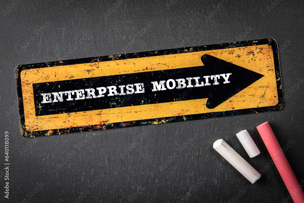 Poster enterprise mobility. yellow directional arrow with text on a dark chalkboard background