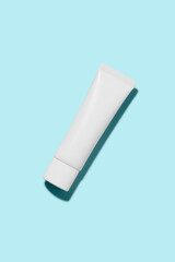 cosmetic white cream tube with sky blue background