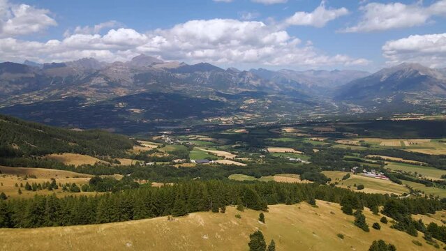 Panoramic aerial view of Champsaur Valley with its mountain range (Chaillol Peak in the distance), Bayard Plateau and Gap basin. The view is from Gleize Pass. Hautes-Alpes, Alps, France