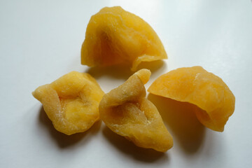 Closeup of four fleshy yellow dried passion fruit slices
