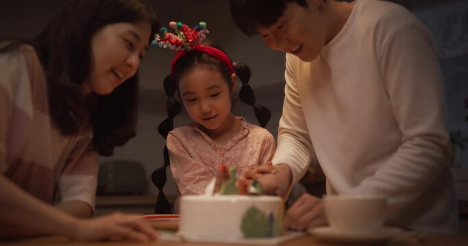 Family Memories: Slow Motion Portrait of Cute Little Girl Cutting her Birthday Cake with the Help of her Parents. Young Korean Couple Celebrating Their Daughter Growin Up, Clapping and Cheering