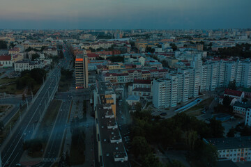 Naklejka na ściany i meble Top view of the evening city, sundown light and shadow