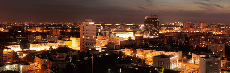 Top view of the night city, lights of lamps and cars in the dark