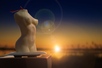 Candles female silhouette against sunset background