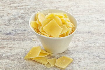 Sliced parmesan cheese heap in the bowl