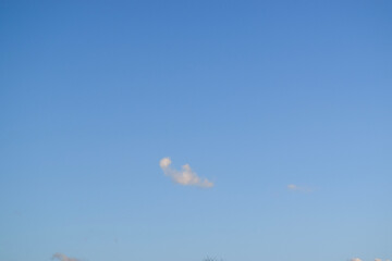 Peaceful blue sky with light clouds