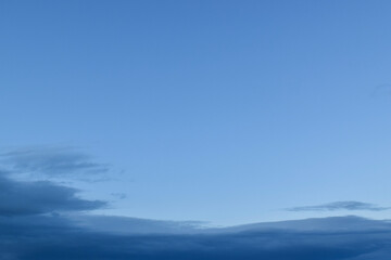 Peaceful blue sky with light clouds