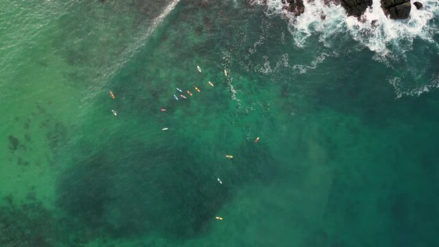 Surfing heights, aerial view of surfers riding waves at Carrizalillo beach, Puerto Escondido, Oaxaca, Mexico