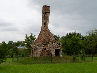 House chimney left after house collapses and rubble cleared. Remnants of the Past: Mantel Chimney...