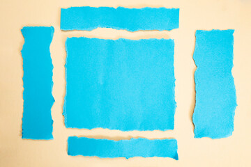 Ripped blue paper strips on beige  background, arranged as webpage