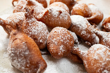 Yogurt doughnuts sprinkled with powdered sugar on a paper towel, soft focus