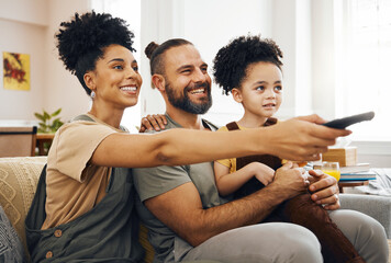 Interracial parents, child and watching tv on sofa, remote and choice for video, movie or show in...