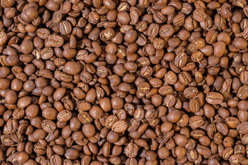 Roasted coffee beans top view wallpaper background.