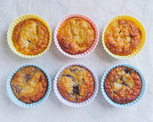 Delicious freshly baked gluten free berry muffins made with coconut flour with no added sugar, top view. Healthy sweet food, flat lay style.