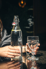 Drink water bottle with glass on table in the restaurant.
