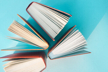 Books on bright blue background education concept top vieBooks on bright blue background education concept top view flat lay