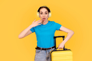 worred woman in blue t-shirt with yellow suitcase late for plane, train   or bus on yellow background. Travel enjoy concept