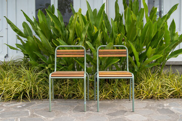 Two empty wooden chairs in the park.