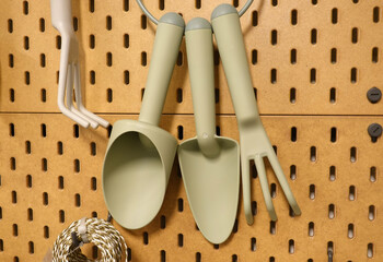 The hoe,trowel,rake, hand fork Hanging on wood wall.
