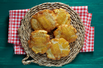 Patacones, also known as tostones, are thick pieces of fried green plantains. Colombian food.