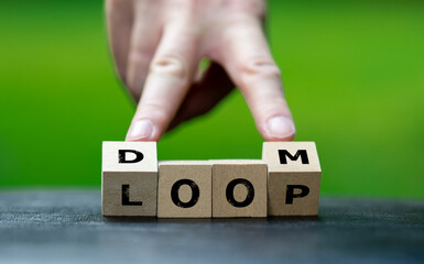 Wooden cubes form the expression 'doom loop'. Symbol for a climate doom loop.
