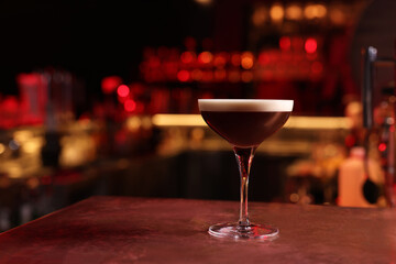Glass of delicious Espresso Martini on bar counter, space for text. Alcoholic cocktail