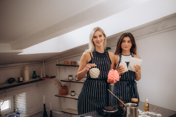 two friends are making a candle to sell