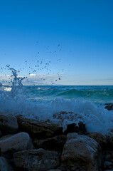 Splashes of waves breaking on stones