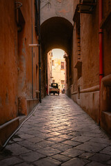 Fototapeta premium Alley in Old Taranto with typical Italian vehicle parked