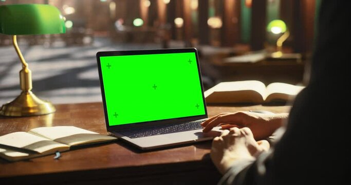 Anonymous High School Graduate in a Solving Homework Assignments on a Laptop Computer with Green Screen Chroma Key Mock Up. Template for Working in Office, Using Computer, Getting Ready for Exams