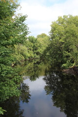 Fototapeta na wymiar Reflection on Yamaska River in Cowansville, Qc