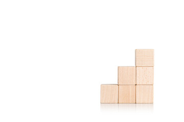 wooden cubes in the form of a ladder with a hand on an isolate white background