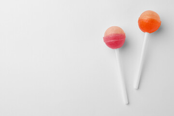 Tasty lollipops on white background, flat lay. Space for text