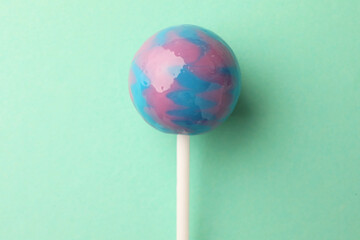 Tasty lollipop on turquoise background, top view