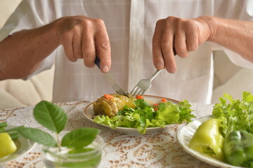 Cropped image of senior man eating
