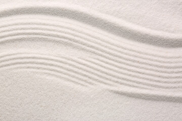 Fototapeta na wymiar White sand with pattern as background, top view. Concept of zen and harmony