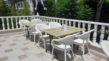Fototapeta na wymiar The interior of an outdoor cafe, a summer terrace with a beautiful balcony, photo