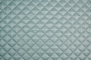Fabric velour quilted close-up. Quilted surface upholstery